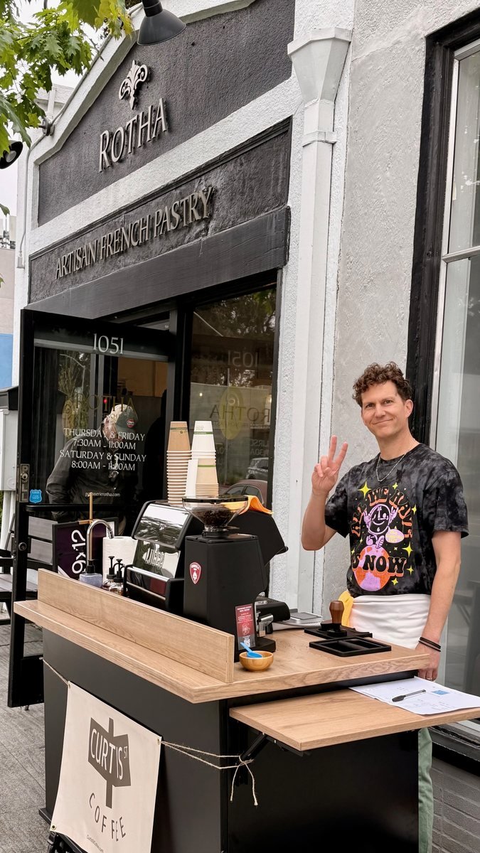 A Curtis St barista at the cart
